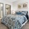 a bedroom with a bed and a fan